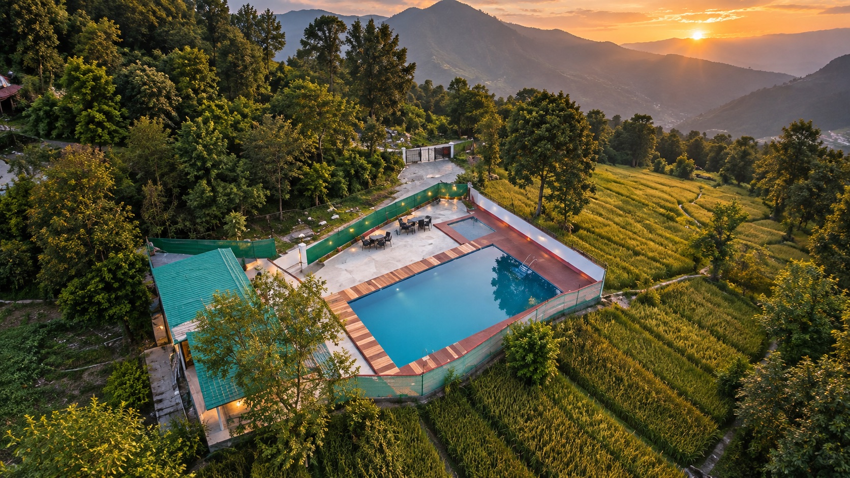 Yash Rock Hotel from the air — the pool, the lawns and the Kangra valley at sunset